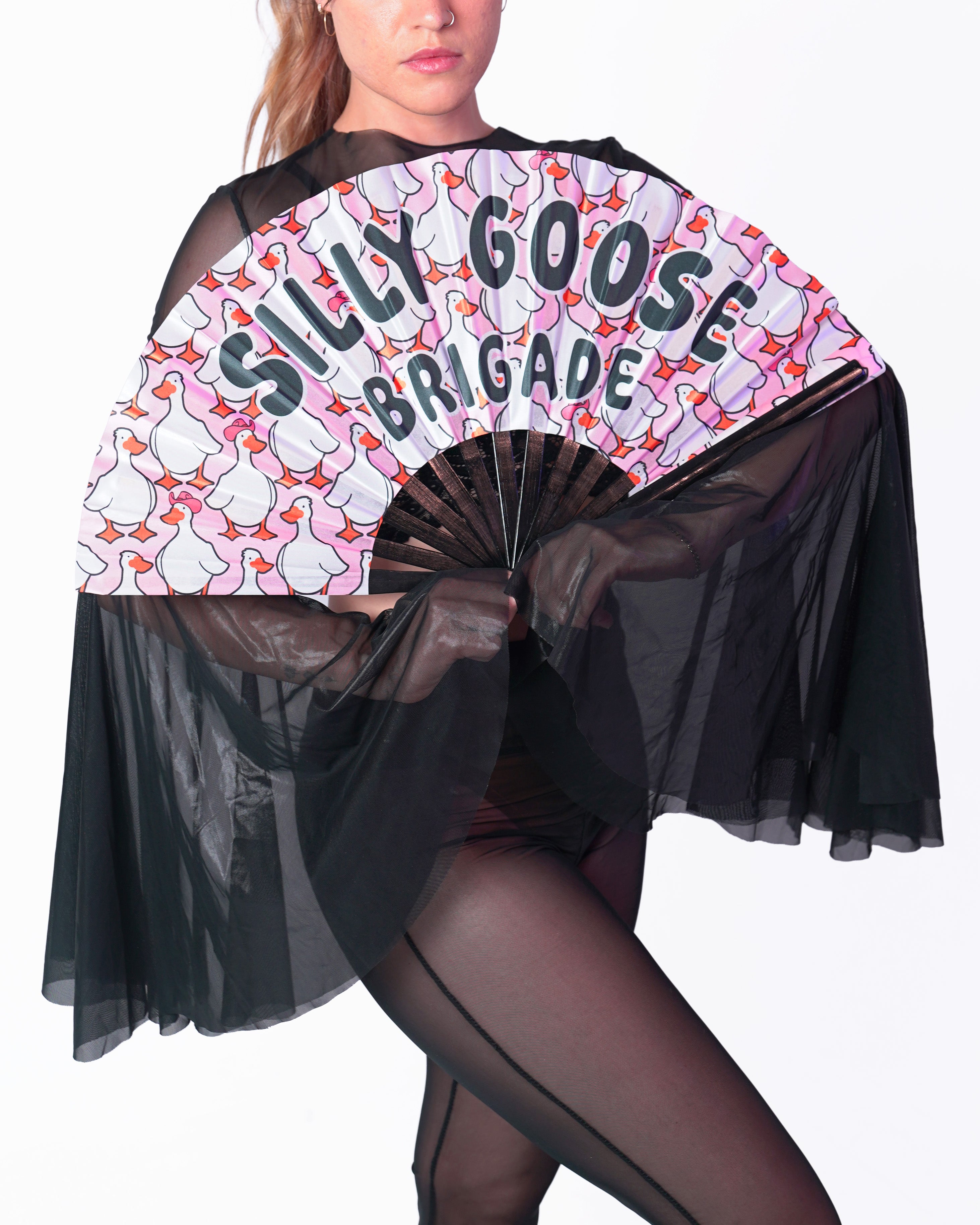 Person holding a fan with 'Silly Goose Brigade' text and goose design on a white background